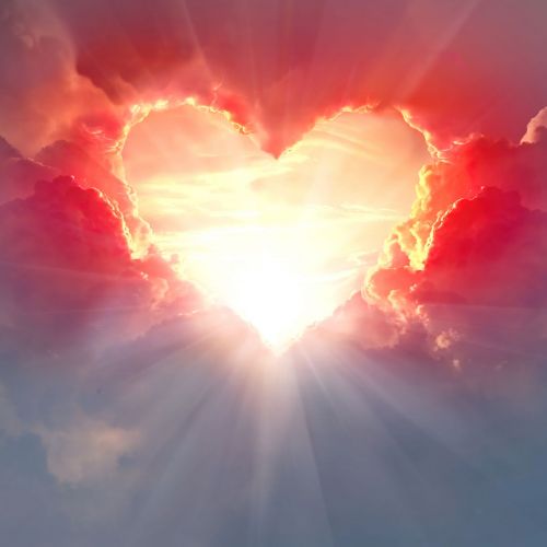 Red heart shaped clouds at sunset. Beautiful love background with copy space.Valentine's Day concept.
