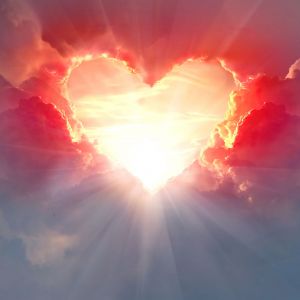 Red heart shaped clouds at sunset. Beautiful love background with copy space.Valentine's Day concept.